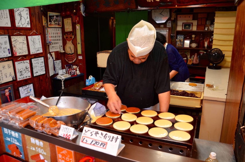 Chef making hotcakes at a food stand in the Osaka Market