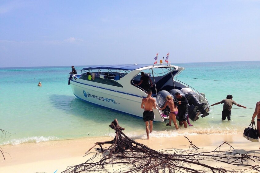 People boarding a boat on a beach on Phi Phi Island