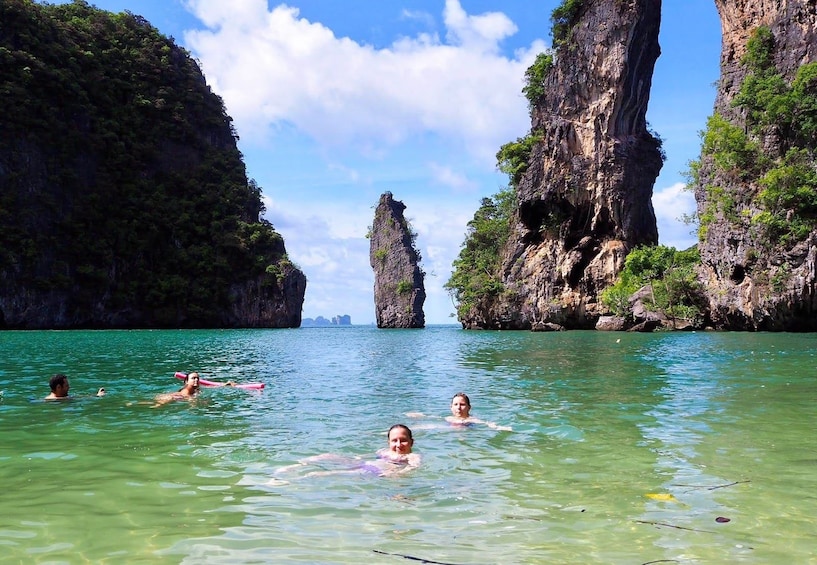 People swimming in the water on Ko Kudu Yai Island