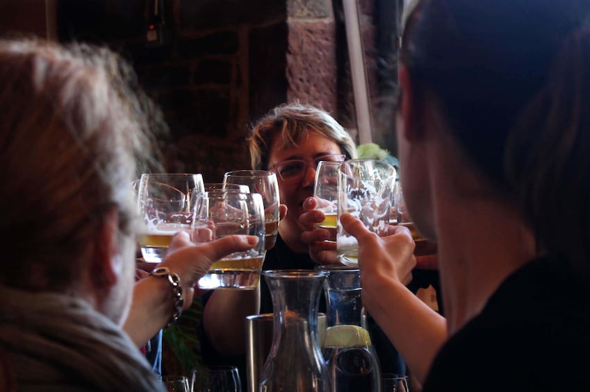 Group toasting with beer on a tour in Glasgow