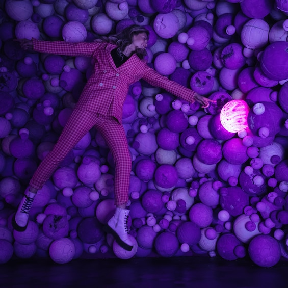 Man lays in Amethyst Ball Cavern at Moco Museum in Amsterdam 