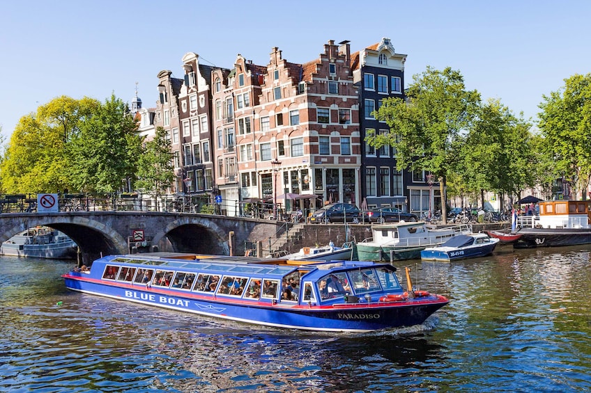 Blue boat in the canals of Amsterdam, Netherlands