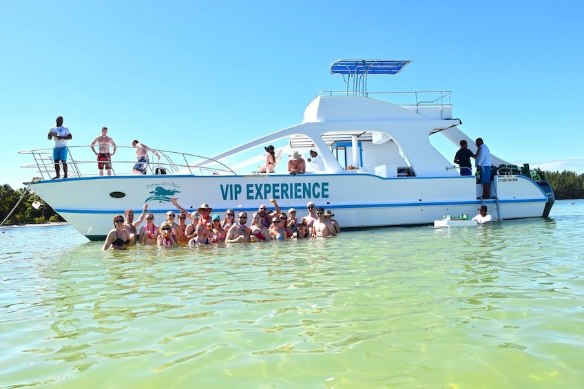 Group standing in the water in front of a catamaran in Punta Cana

