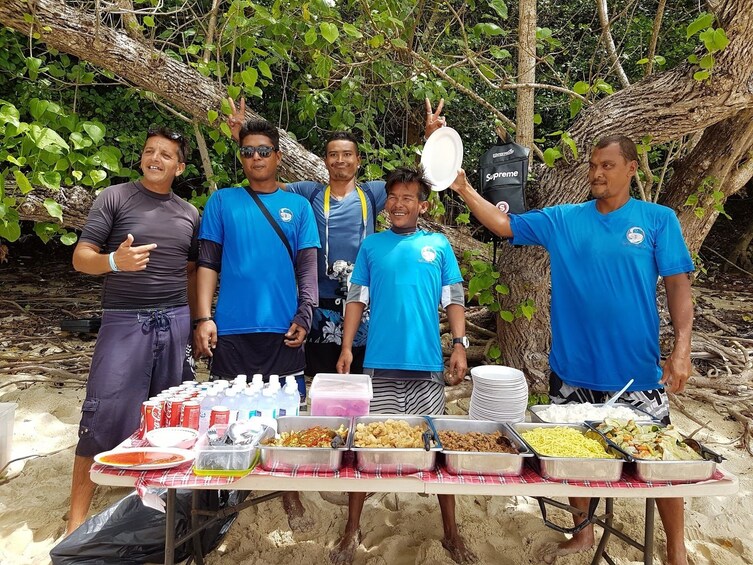 Tour guides with lunch for the tour on the beach in Similan Islands in Thailand