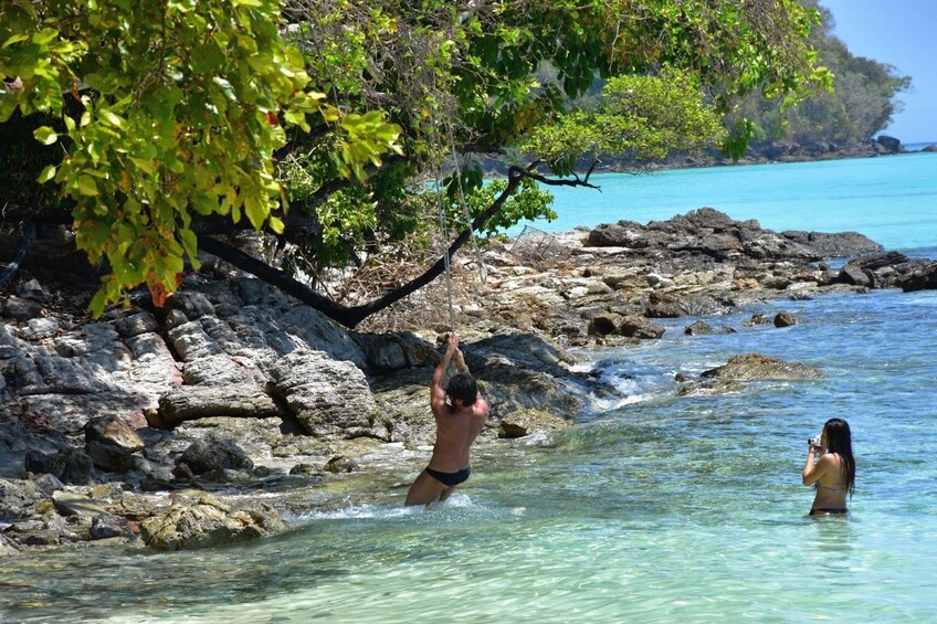 Couple swimming off the coast of an island in Thailand