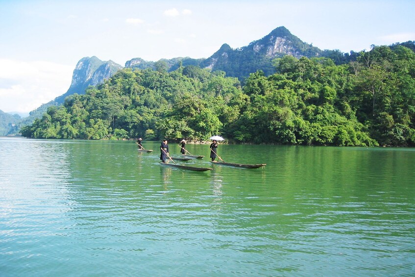 Wooden boats on Ba Bể Lake in Vietnam