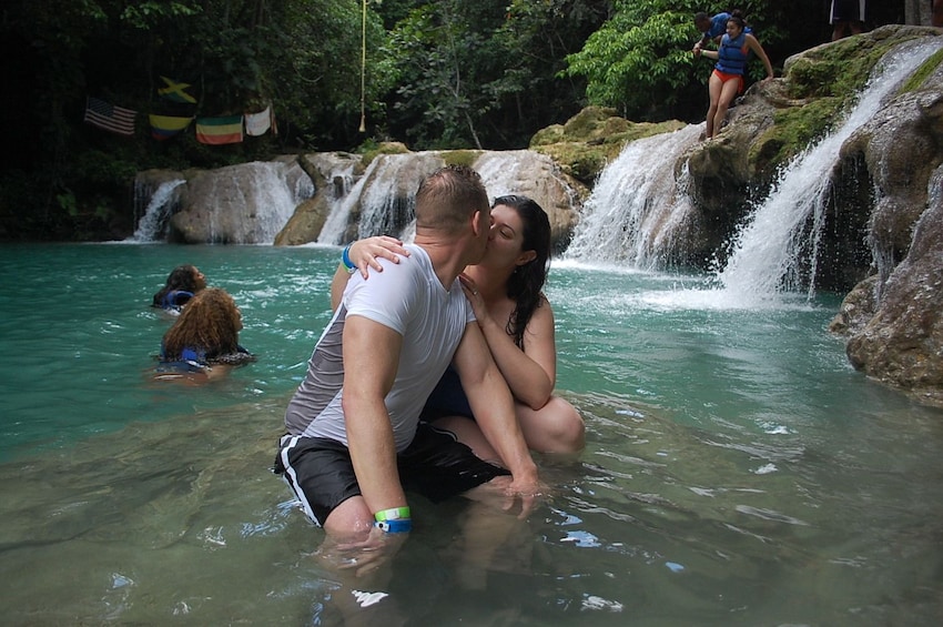 Couple kissing in the water in Jamaica