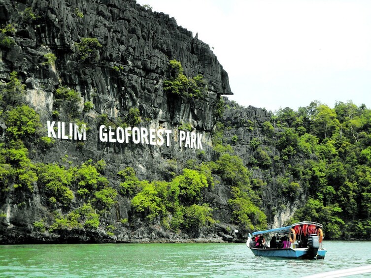 Show item 3 of 4. Group exploring Kilim Geoforest Park by boat