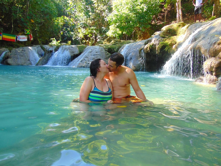 Couple kissing in the water in Jamaica