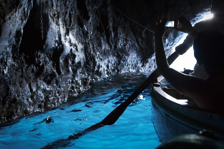 Boating group in the Blue Grotto cave in Italy