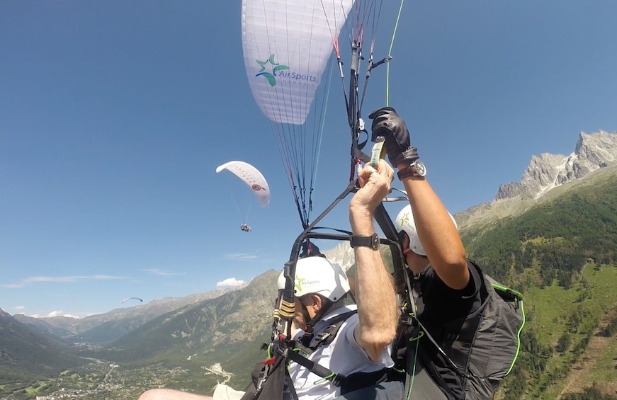 Show item 5 of 10. Closeup of paragliders over French Alps on a sunny day