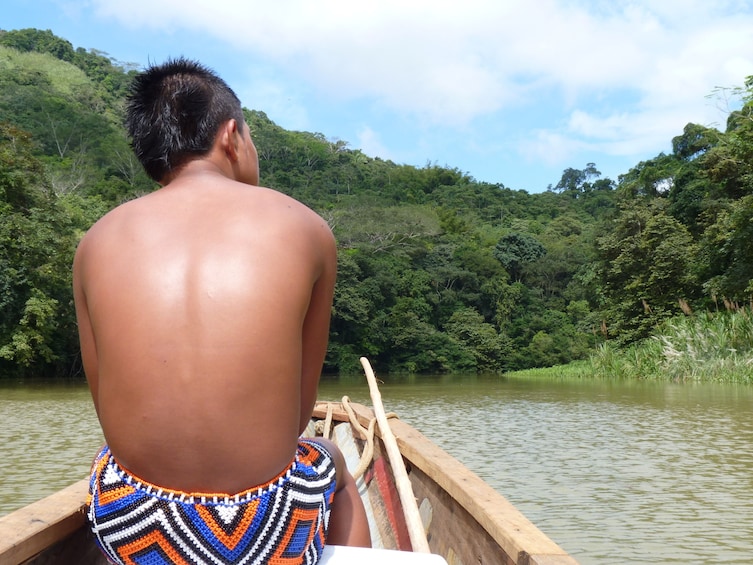 Man on a traditional piraguas  along the Chagres River banks 