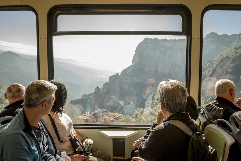 Tourists enjoying incredible views of Montserrat from the cogwheel train