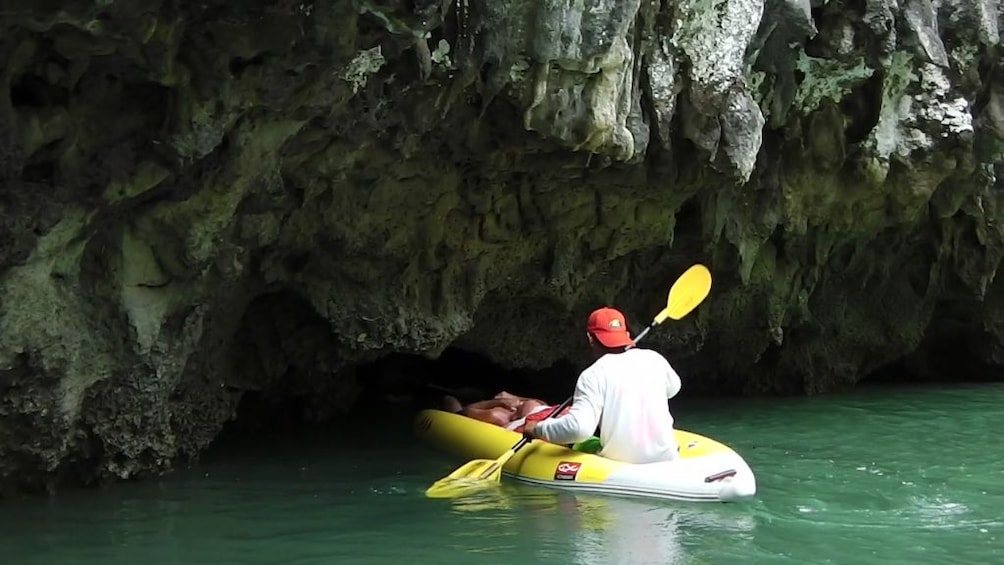 Tourist kayaking to the limestone caves  at Ao Phang Nga National Park
