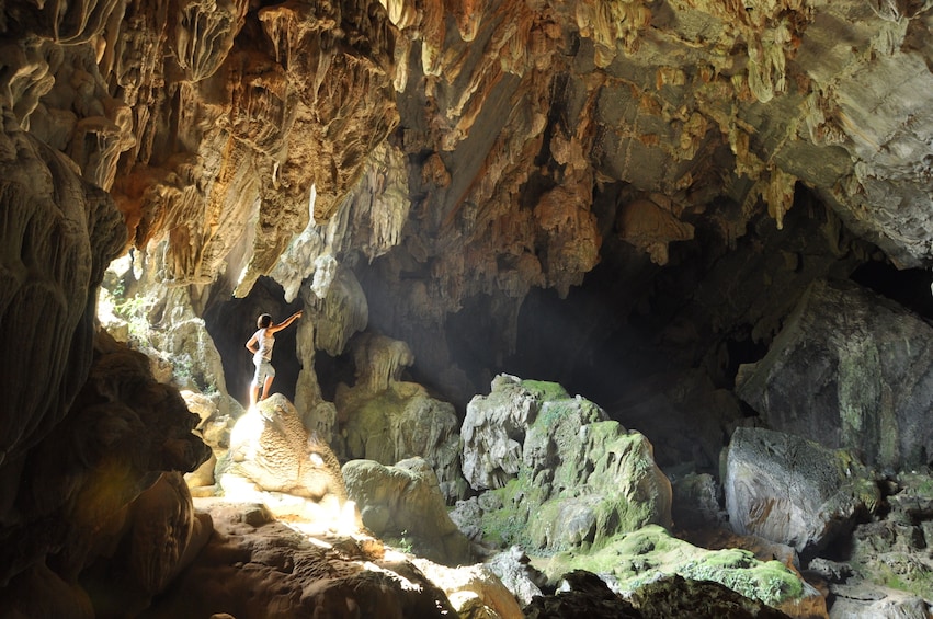 Woman visits a cave in Vang Vieng