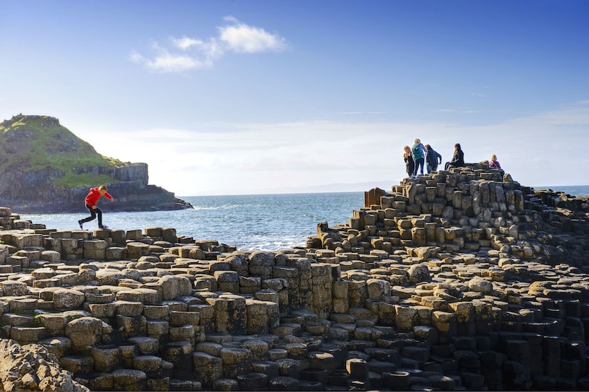 People walking on the rocks at Giants Causeway in Ireland