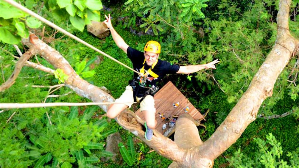 Person hangs from a rope in the Hanuman Ziplining Experience