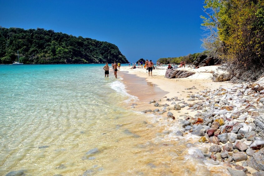 Visitors relaxing, sunbathing and walking around the island of Koh Rok Nai