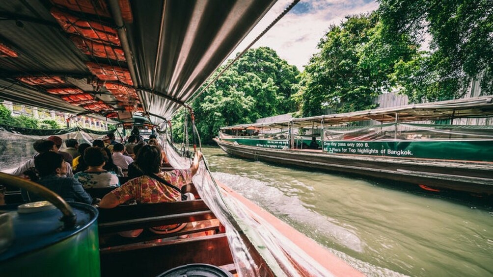 Group on a long tail boat cruising down the Bangkok Klong (canal) 