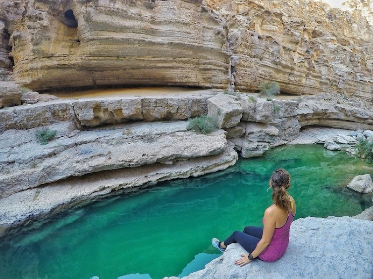 Woman sitting in a canyon in Oman