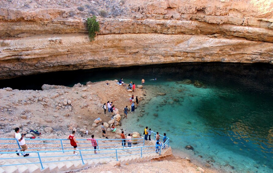 Tour group walking down to lake in Oman