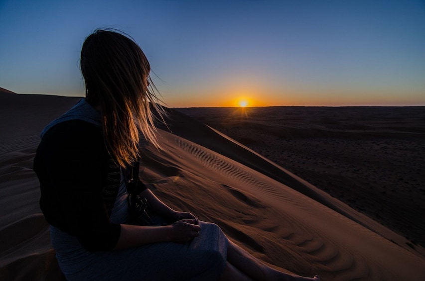 Tourist admiring the sunset in Muscat 