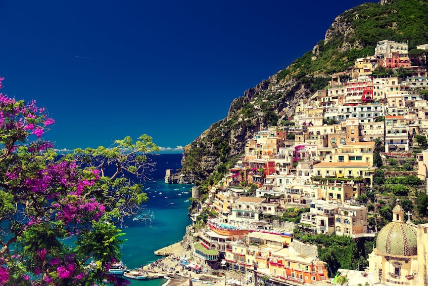 Stacked colorful buildings with deep blue sea and sky in Positano, Italy