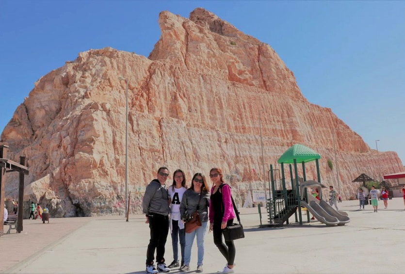 Tour group in front of mountain in Al Ain