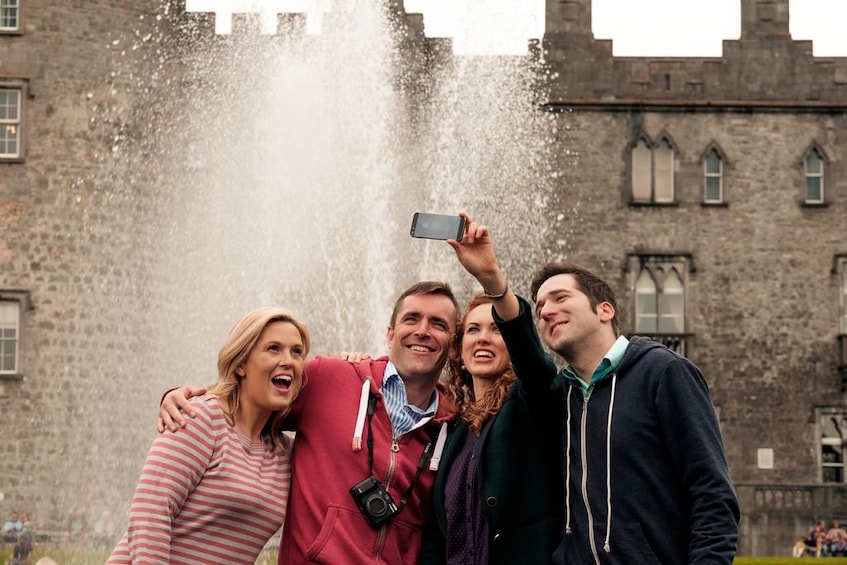 Tourists pose for a selfie at Kilkenny Castle