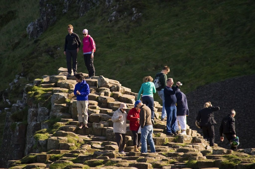 Tour group on the rocks at Giants Causeway in Ireland