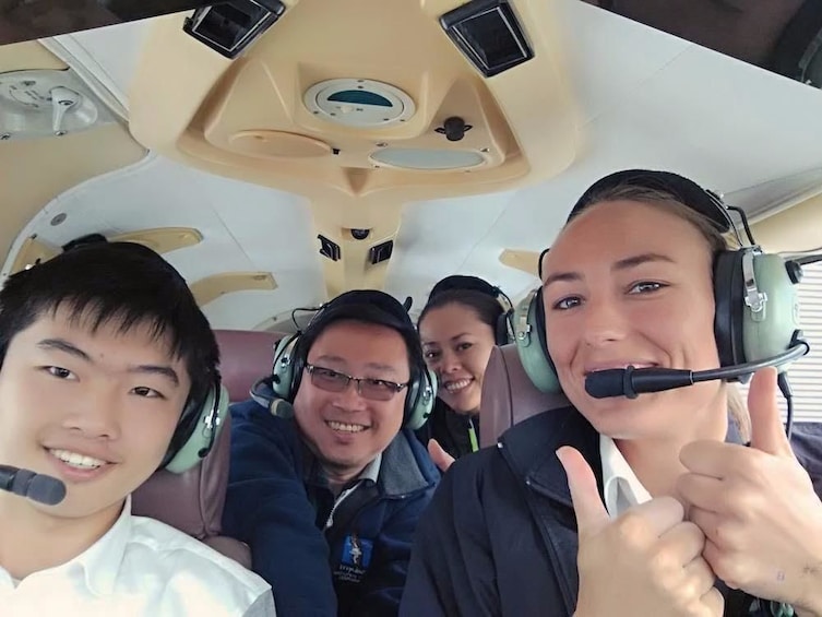 Show item 1 of 5. Smiling group in a plane in New Zealand