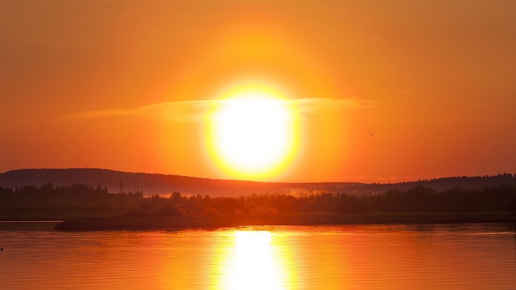 Sunset view of the Finnish forest lake in Rovaniemi