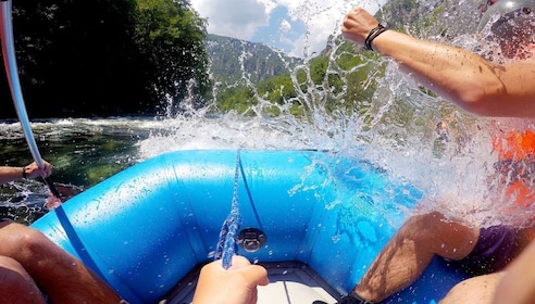 Perspective shot from blue raft during white water rafting