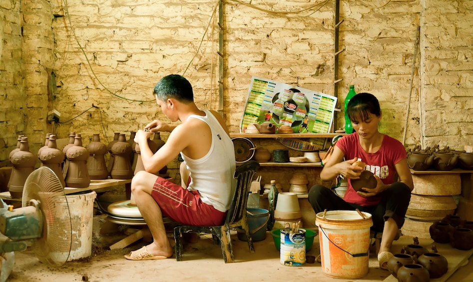Locals working on pottery in Vietnam