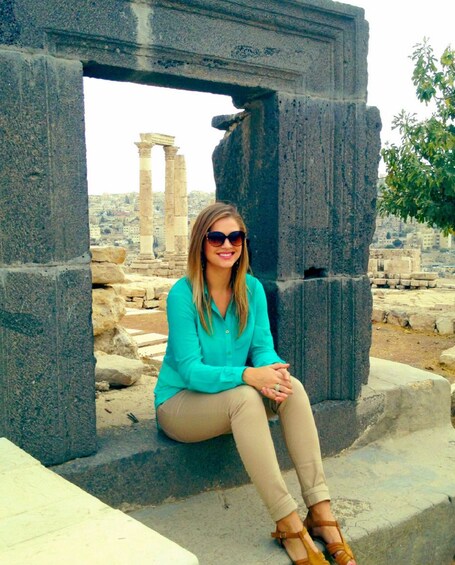Woman sitting on ruins of The Amman Citadel