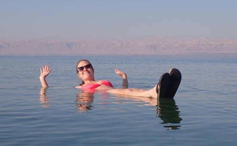 Woman floating on the Dead Sea 