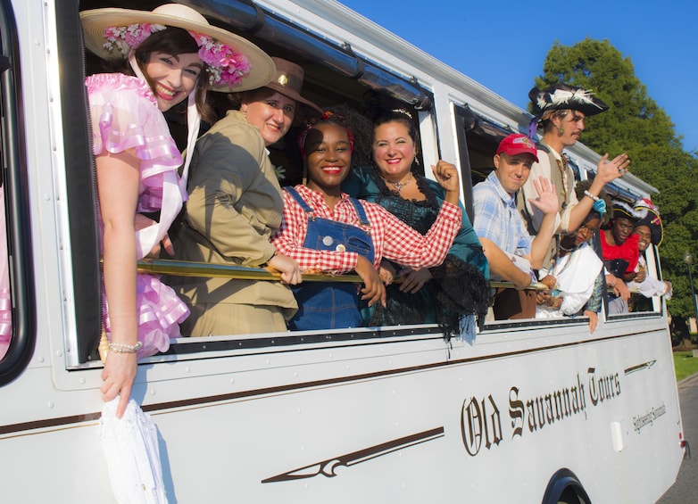 Show item 1 of 7. Performers in costume lean out of tour bus