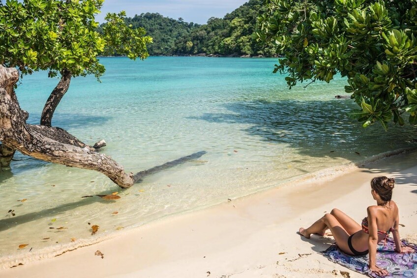 Woman lounges on beach in Surin Islands