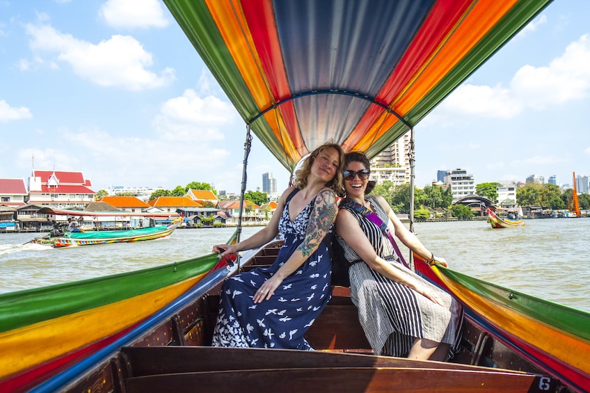 Show item 2 of 10. Couple of women on a boat in Bangkok