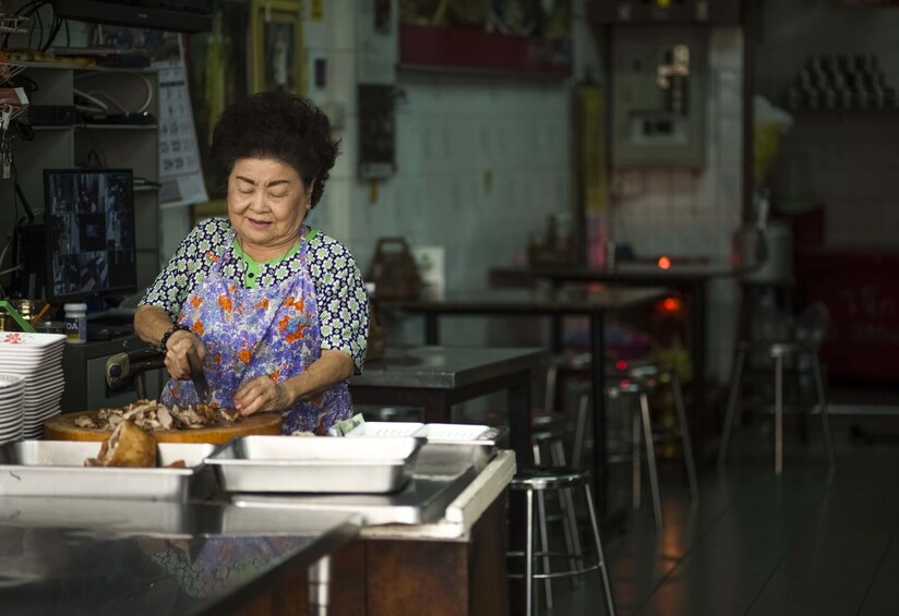Show item 5 of 10. Woman preparing food in Bangkok