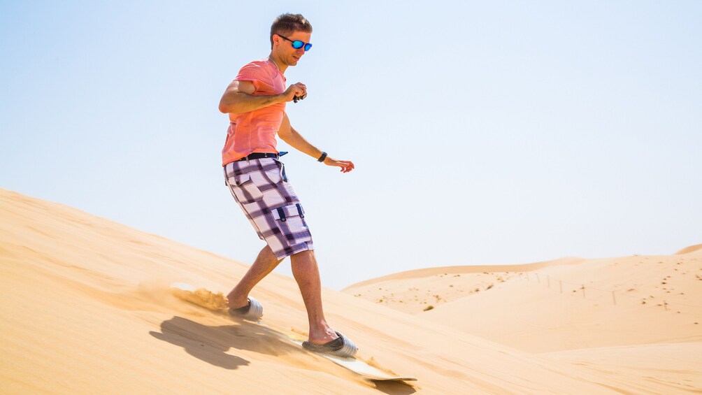 Man sand boarding in Doha