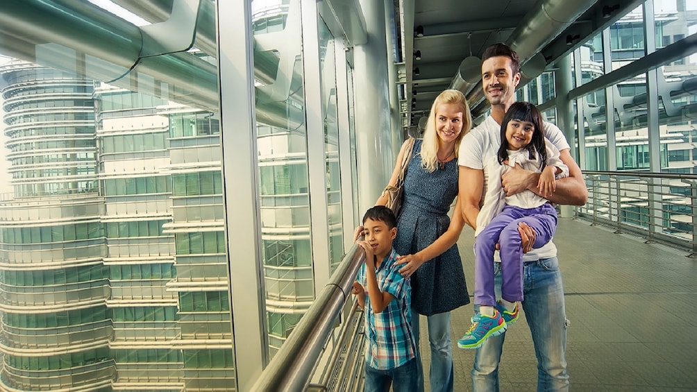 Family poses at top of Petronas Twin Towers