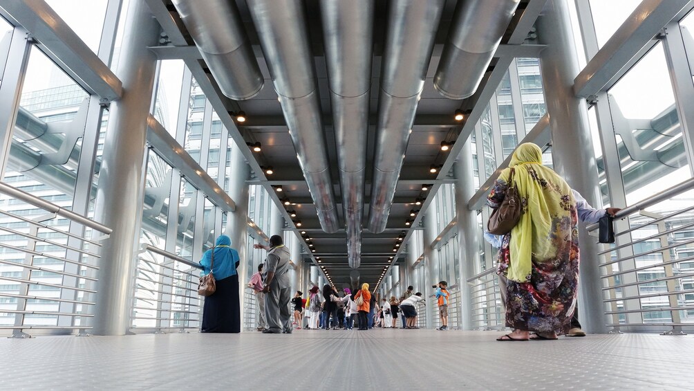 Tourists look out windows of Petronas Twin Towers