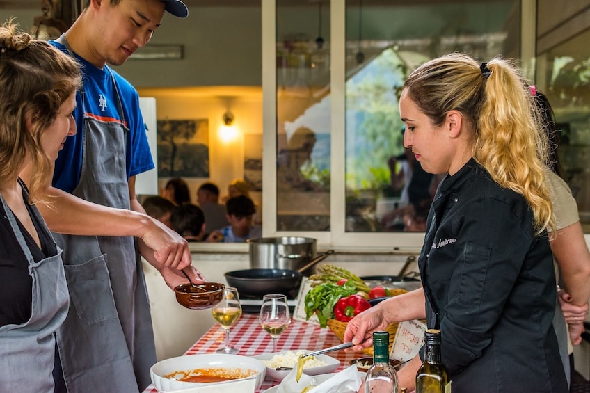 Chef watches guests work on their meals in Sorrento, Italy