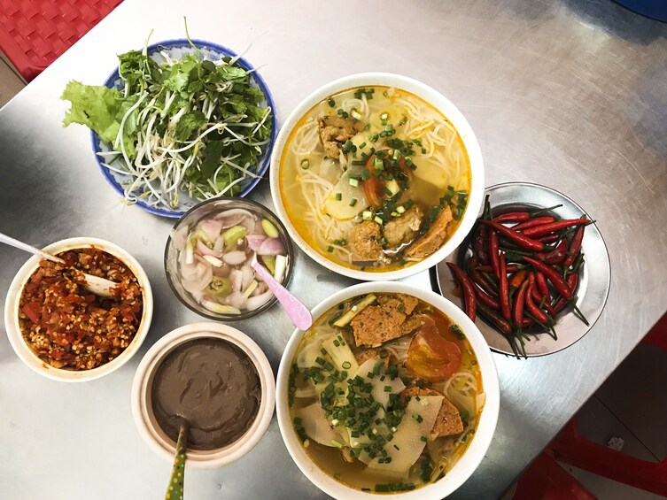 Motorbike food tour with driver in Ao Dai from Da Nang