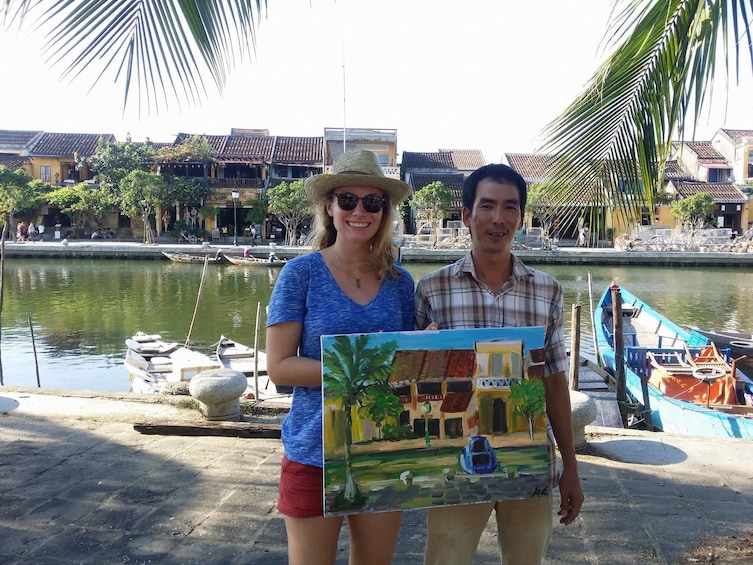 Couple holding their painting in Hoi An Ancient Town 