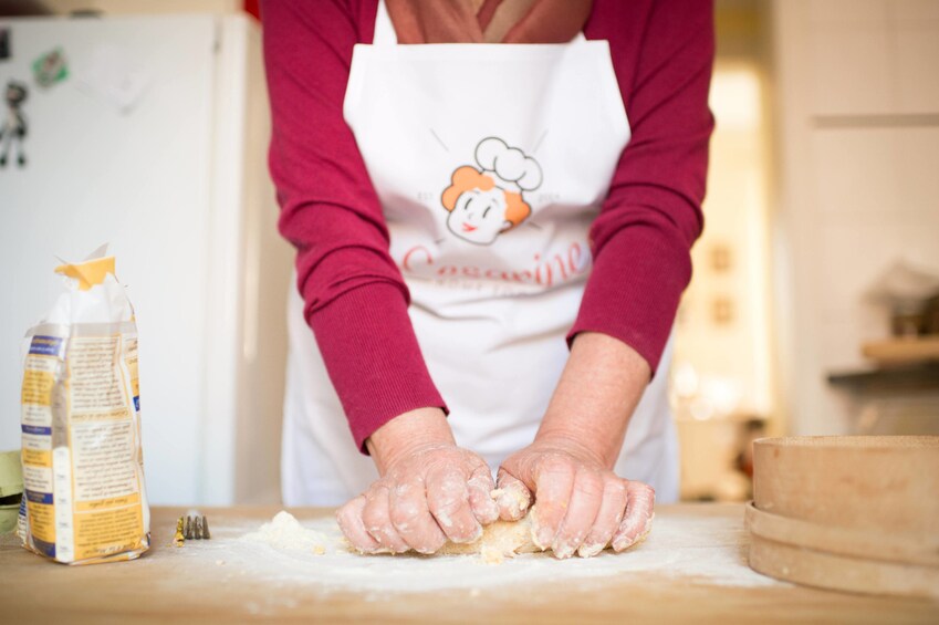 Woman working with dough in a kitchen in Arezzo