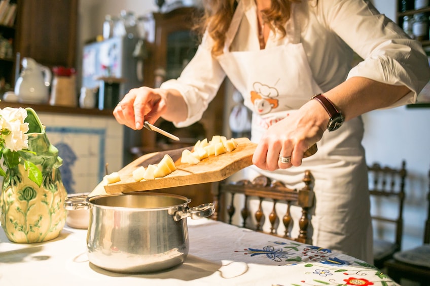 Woman cooking at a Cesarina’s home in Siena