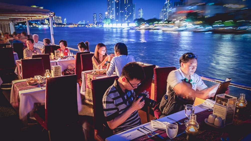 Guests enjoying dinner aboard the Chao Phraya Princess Cruise