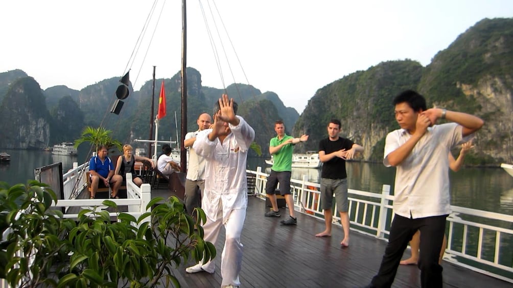 Guests participate in Tai Chi lesson on board boat